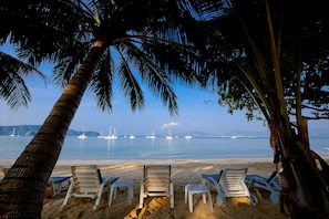On the beach, sun-loungers, beach umbrellas, beach towels