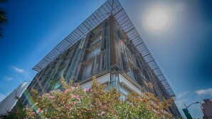 A modern building with a glass facade and a triangular design.