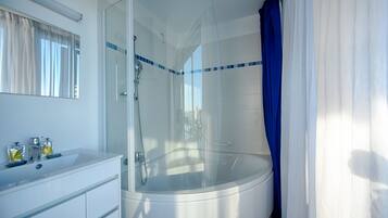 Combined shower/tub, deep soaking tub, hair dryer, bathrobes