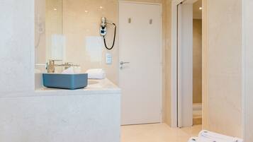 A modern bathroom with a bathtub, a sink, and a mirror.