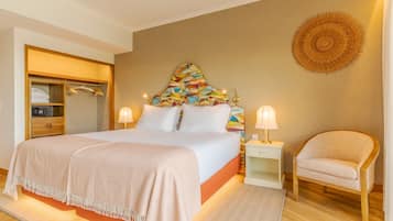 A bedroom with a bed, bedside tables, a chair, a wardrobe, and a decorative wall piece.