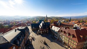 A town square with historic buildings, a prominent church, and a clear view of the surrounding landscape. - A-ROSA Gothisches Haus Wernigerode (Wernigerode)