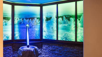 Panoramic views of snow-covered landscapes unfold through large windows, framing a serene winter scene.