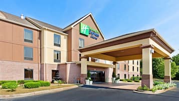 A Holiday Inn Express & Suites hotel with a covered entrance and a brick facade.