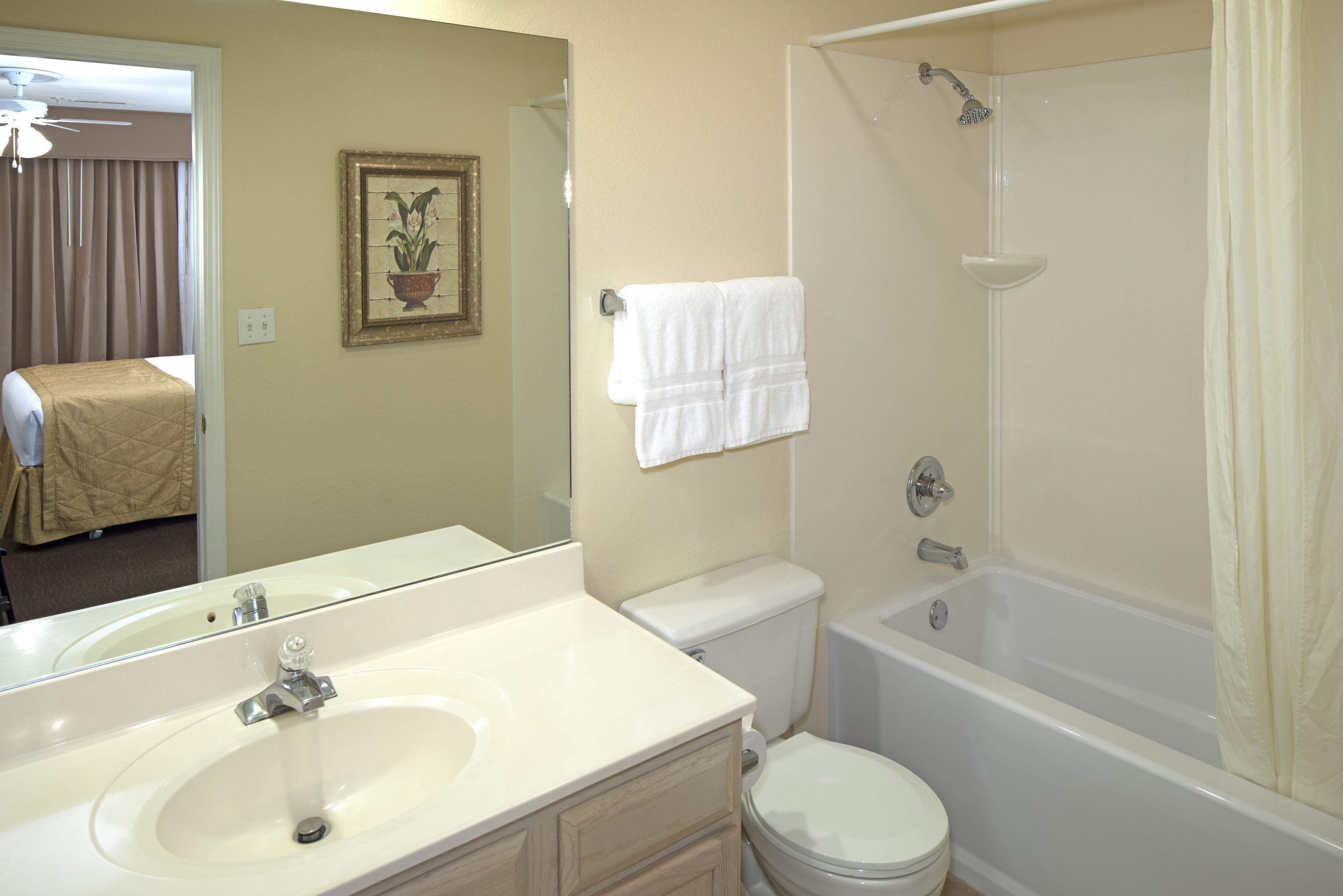 A bathroom with a sink, toilet, and bathtub.