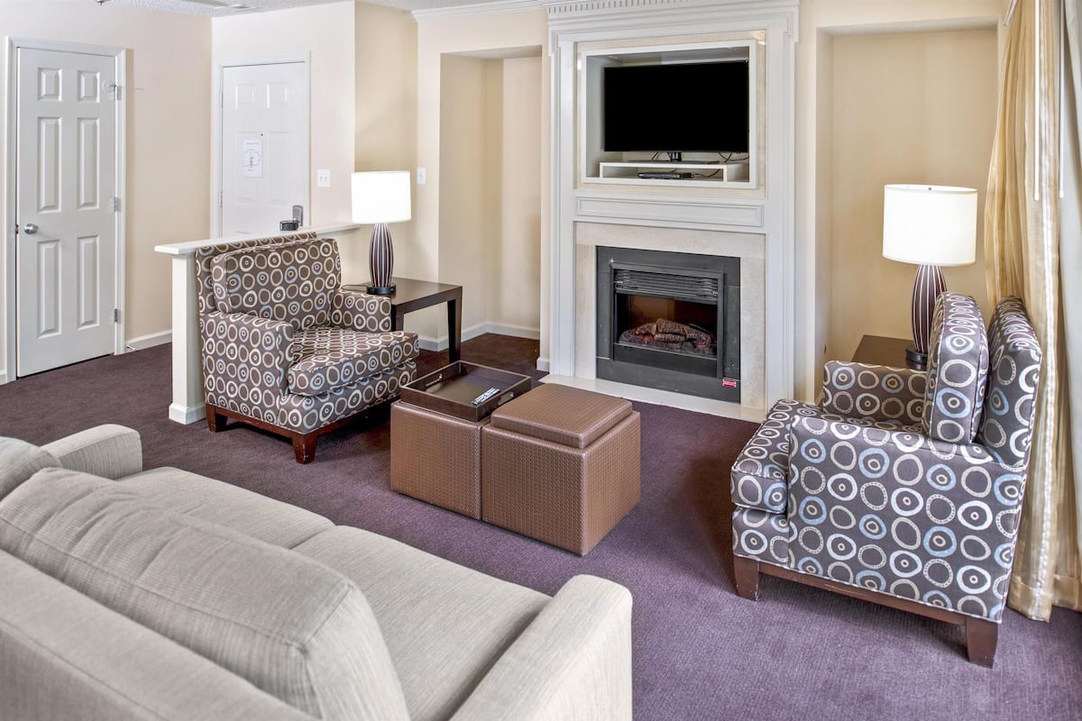 Suite, 2 Bedrooms | Living area | 32-inch TV with cable channels, fireplace, DVD player