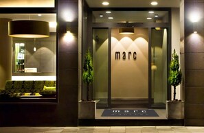 A modern building entrance with the name 'marc' displayed prominently. - marc münchen - Adults Only (Munich)