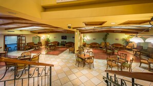 A lobby with multiple seating areas, including sofas and tables, and a sign indicating a lobby bar. - Mary's Well Nazareth By Dan Hotels (Nazareth)
