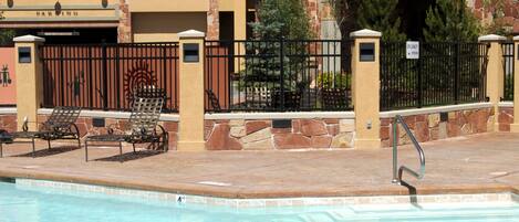 A pool area with lounge chairs and a building labeled "Sundial Lodge."