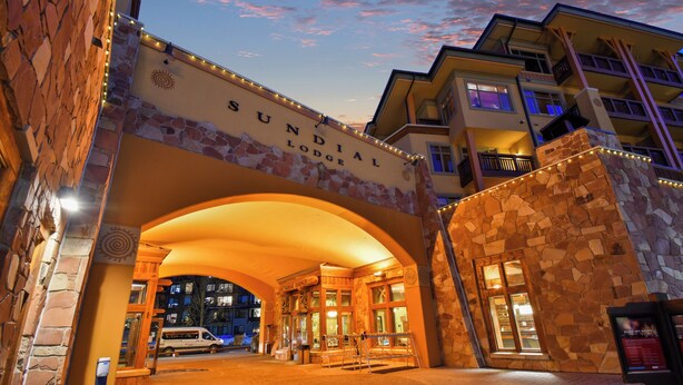 The Sundial Lodge entrance with stone architecture and a welcoming archway.