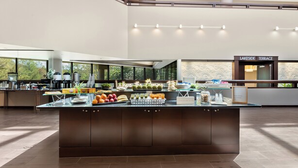 A modern kitchen with a central island, a coffee station, and a sign reading "LAKESIDETERRACE".