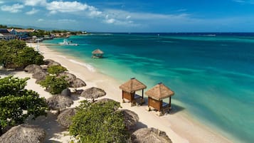 On the beach, white sand, free beach cabanas, sun loungers