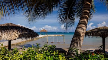 On the beach, white sand, free beach cabanas, sun-loungers