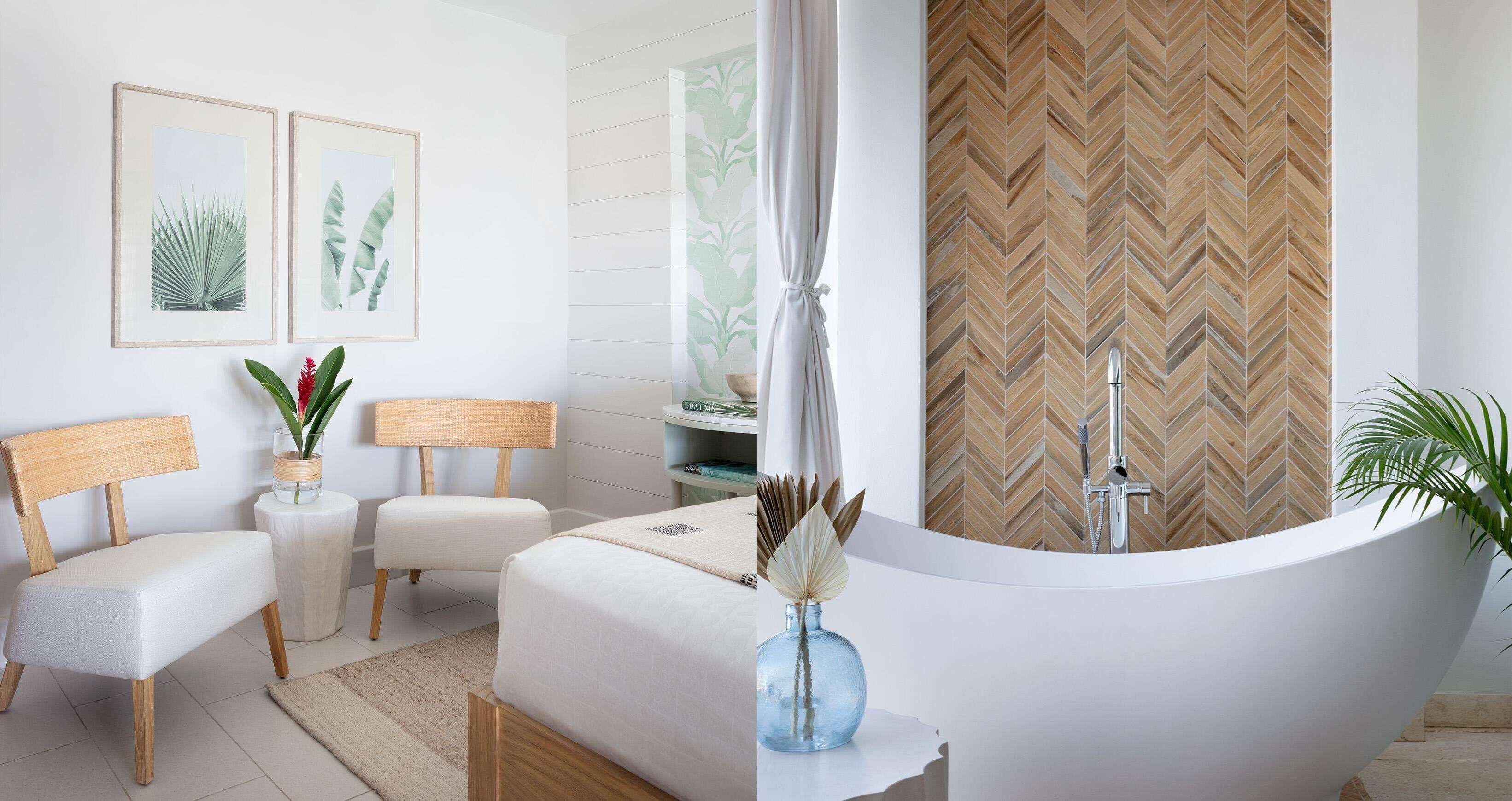 A modern bathroom with a freestanding bathtub, a wooden herringbone-patterned wall, and two framed botanical prints on the wall.