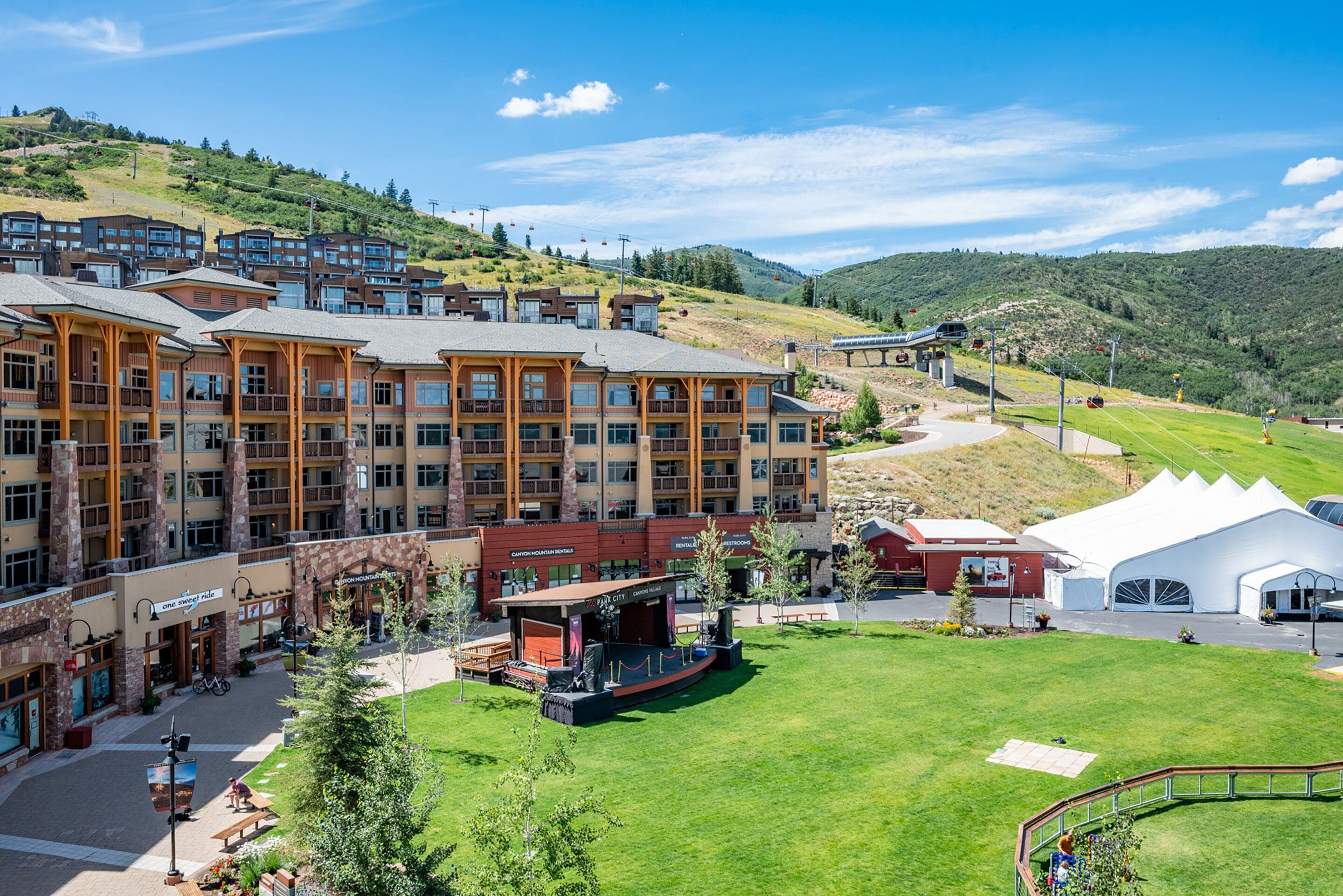 A hotel with multiple floors, outdoor seating, and a stage for events.