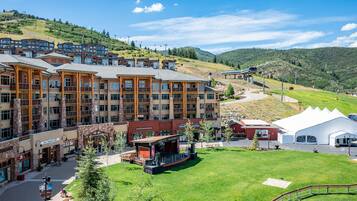 A hotel with multiple floors, outdoor seating, and a stage for events.