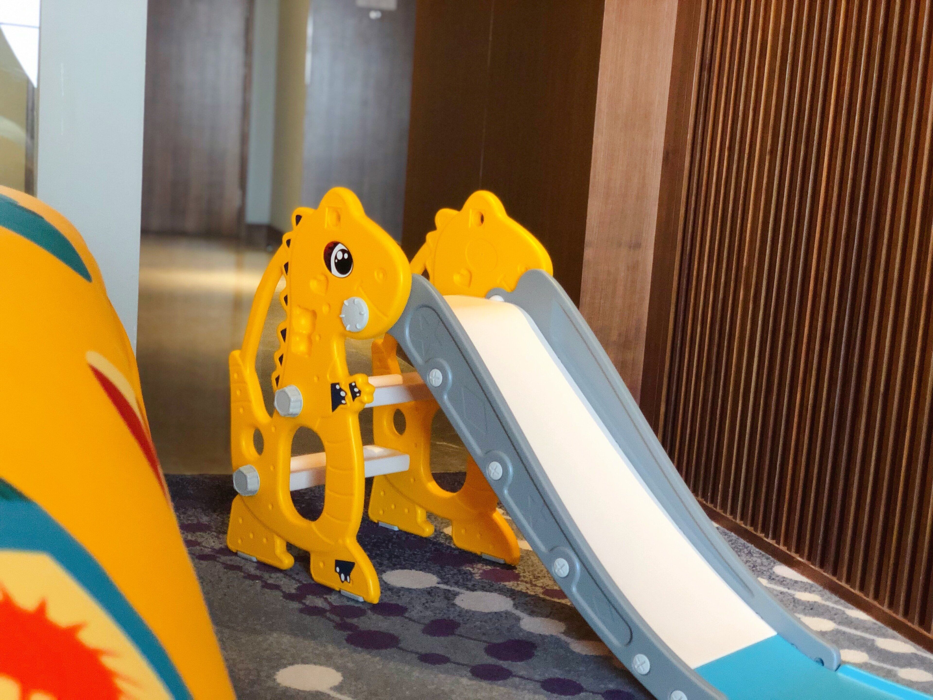 A children's play area with a slide and climbing structures.