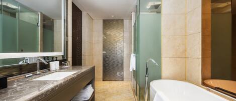 A modern bathroom with a double sink, a large mirror, a glass shower enclosure, and a bathtub.