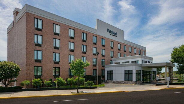 A Fairfield by Marriott hotel with a brick facade, multiple windows, and a covered entrance.