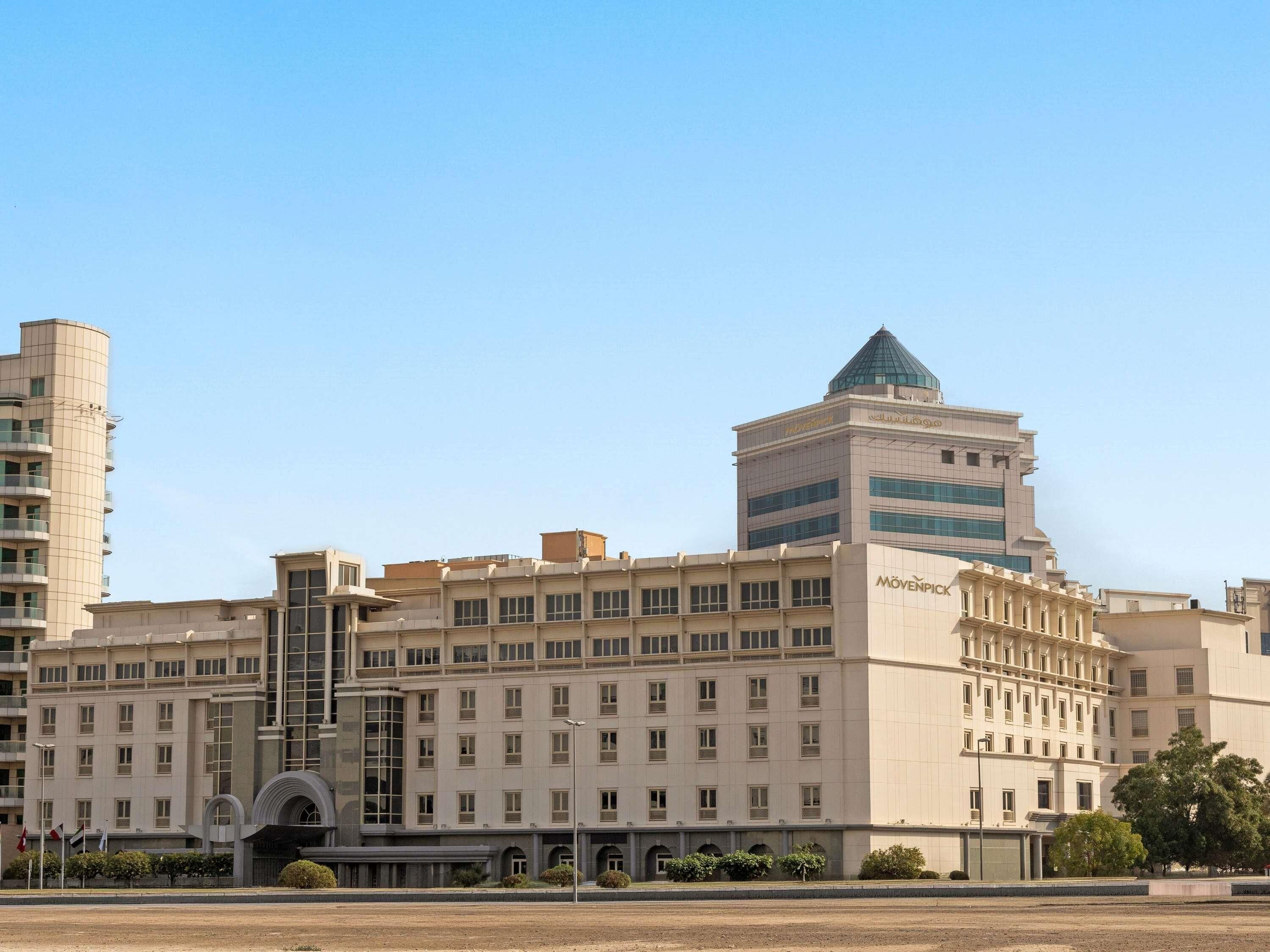 A multi-story building with a prominent tower and a large entrance.