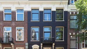 A multi-story hotel with a classic facade, featuring a prominent 'HOTEL' sign above the entrance. - Hotel The Neighbour's Magnolia (Amsterdam)