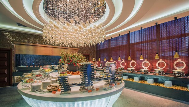 A buffet setup with various food items and a decorative centerpiece.