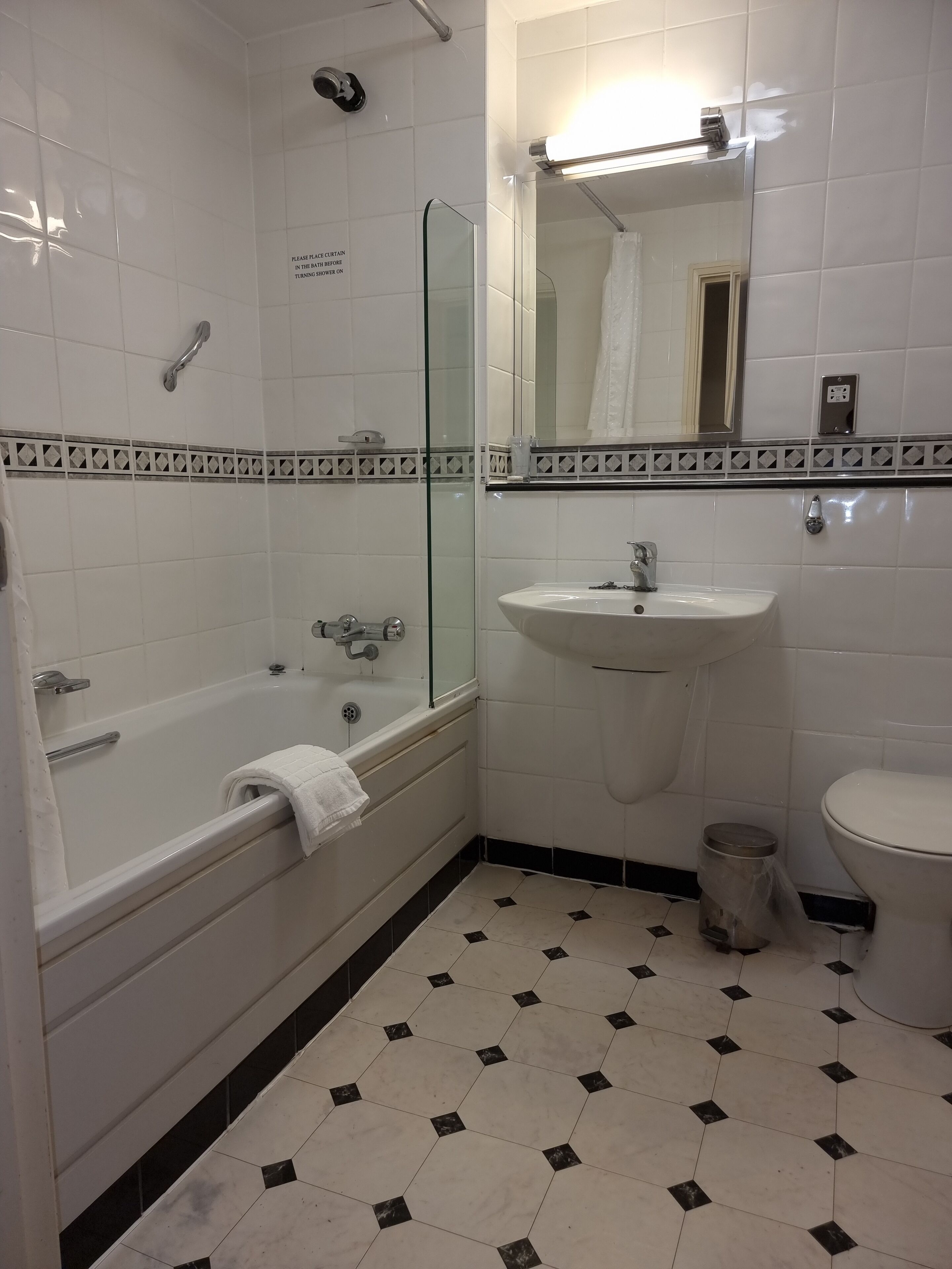 A bathroom with a bathtub, a sink, and a toilet.