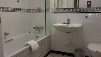 A bathroom with a bathtub, a sink, and a toilet.