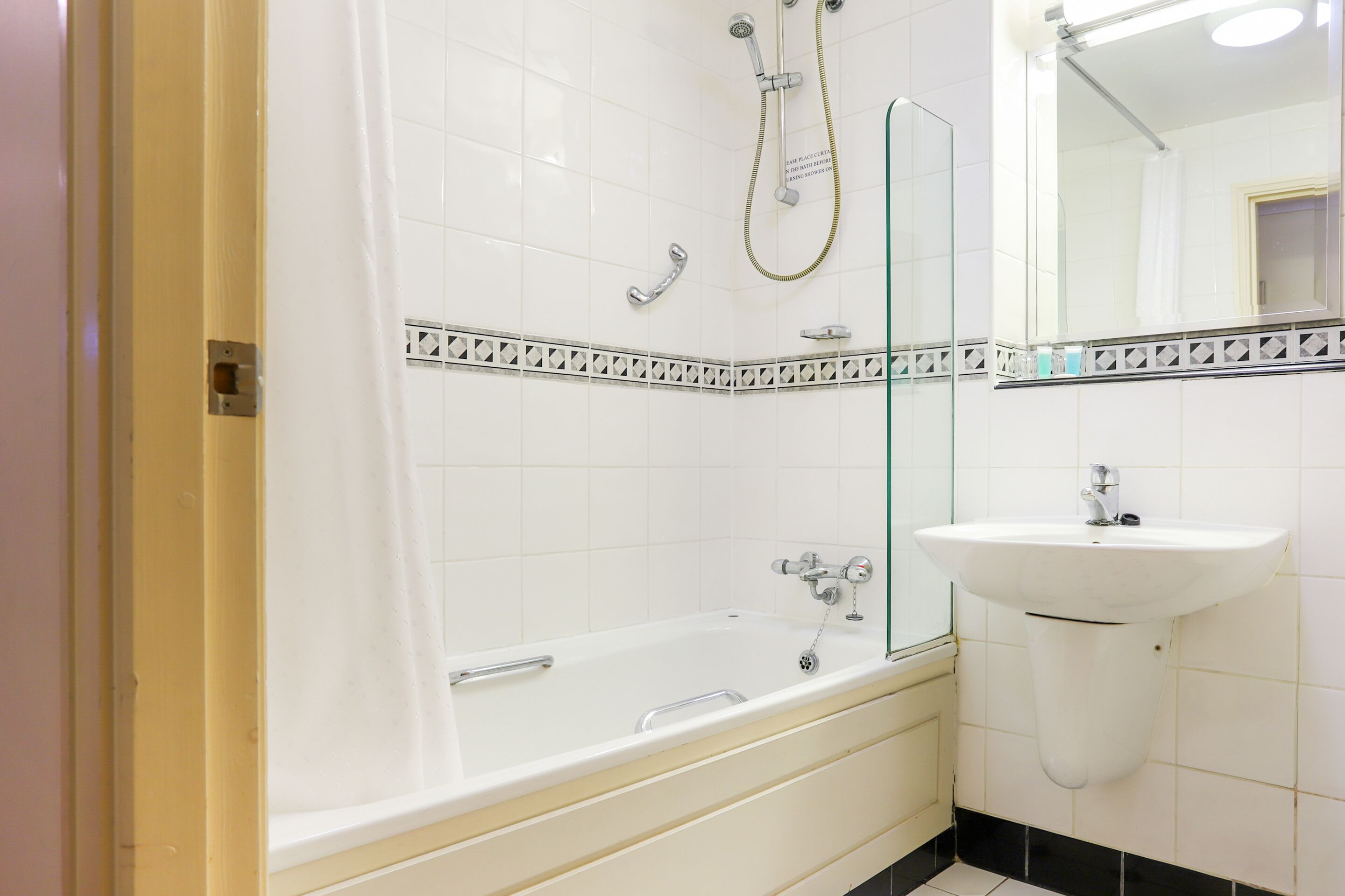 A bathroom with a bathtub, a sink, and a shower.