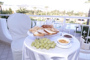 Enjoy a meal in style at this beautifully set outdoor dining area, complete with a round table and comfortable seating.
