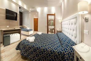 Superior Triple Room | Minibar, in-room safe, desk, cots/infant beds