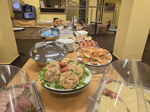 A buffet setup with various food items including salads, sandwiches, and pastries. - Mokinba Hotels Sant'Ambroeus (Milan)