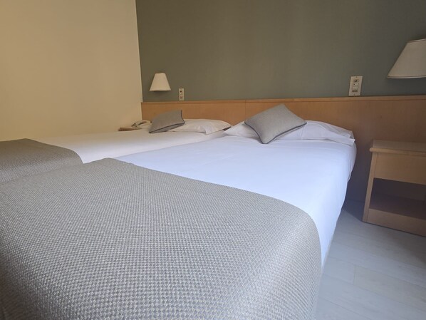 A hotel room with two beds, a nightstand, and a lamp. - Mokinba Hotels Sant'Ambroeus (Milan)