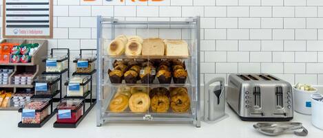 A bakery display with various baked goods and a toaster.