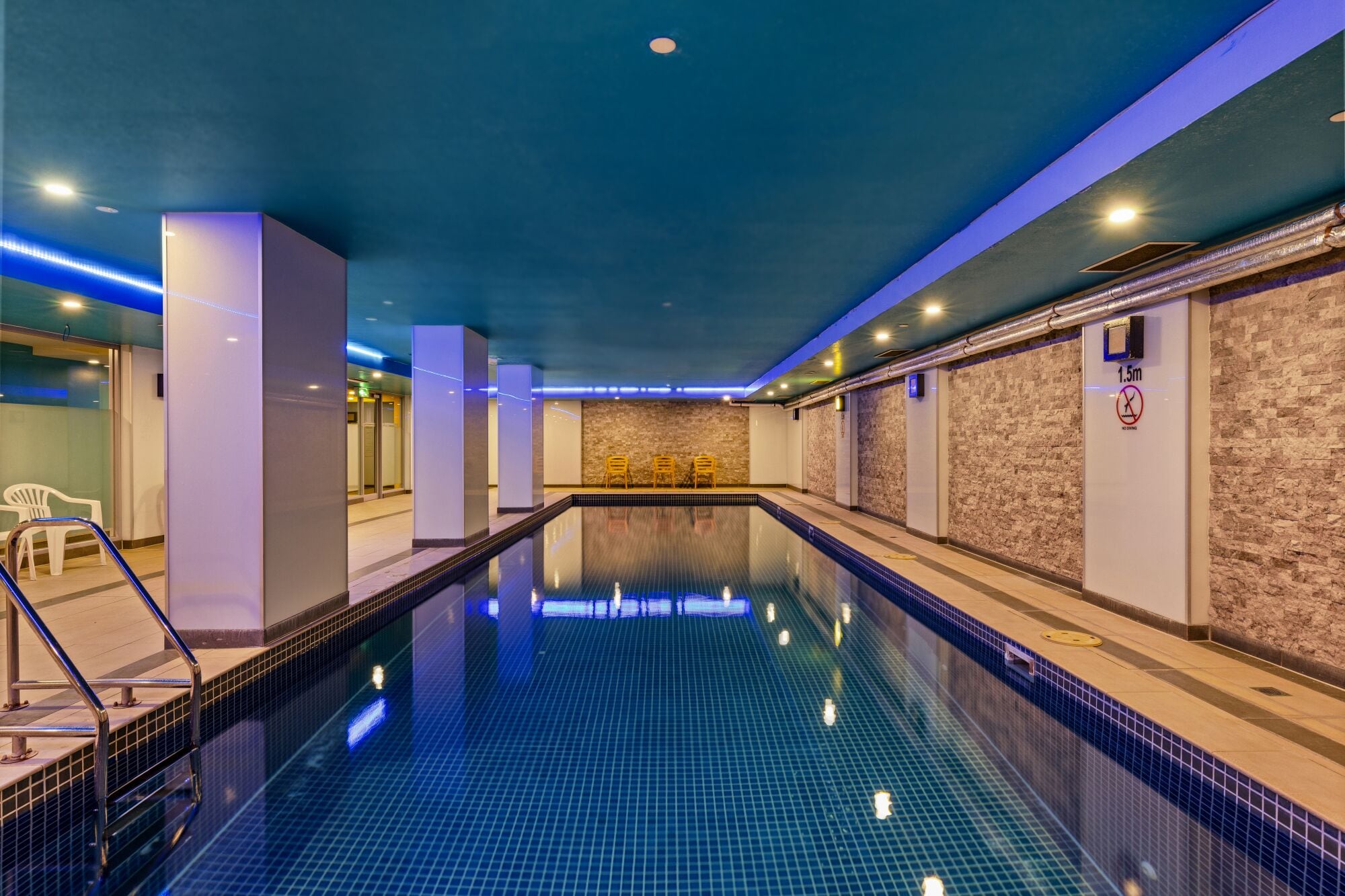 Indoor pool, open 6:00 AM to 9:00 PM, pool loungers