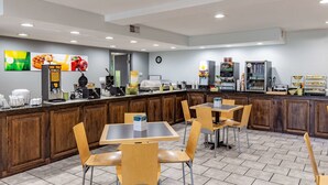 A modern cafe with wooden counters, multiple seating areas, and a variety of coffee machines. - Quality Inn Branson - Hwy 76 Central (Branson)
