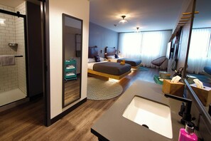 Enjoy a spacious room with a large mirror, central sink, and comfortable seating area.