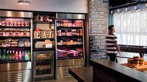 A food display area with refrigerated sections and a chalkboard menu listing various dishes.