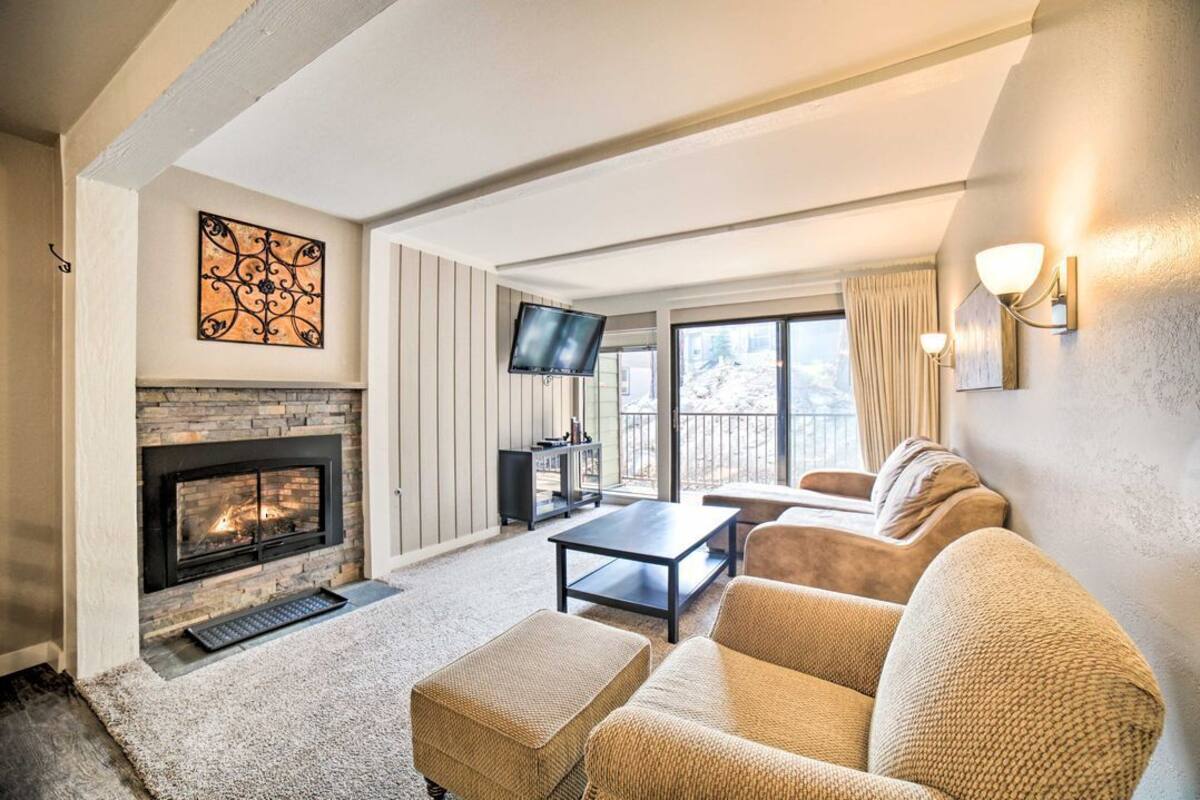 A living room with a fireplace, a television, and a sofa.
