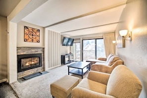 A living room with a fireplace, a television, and a sofa.