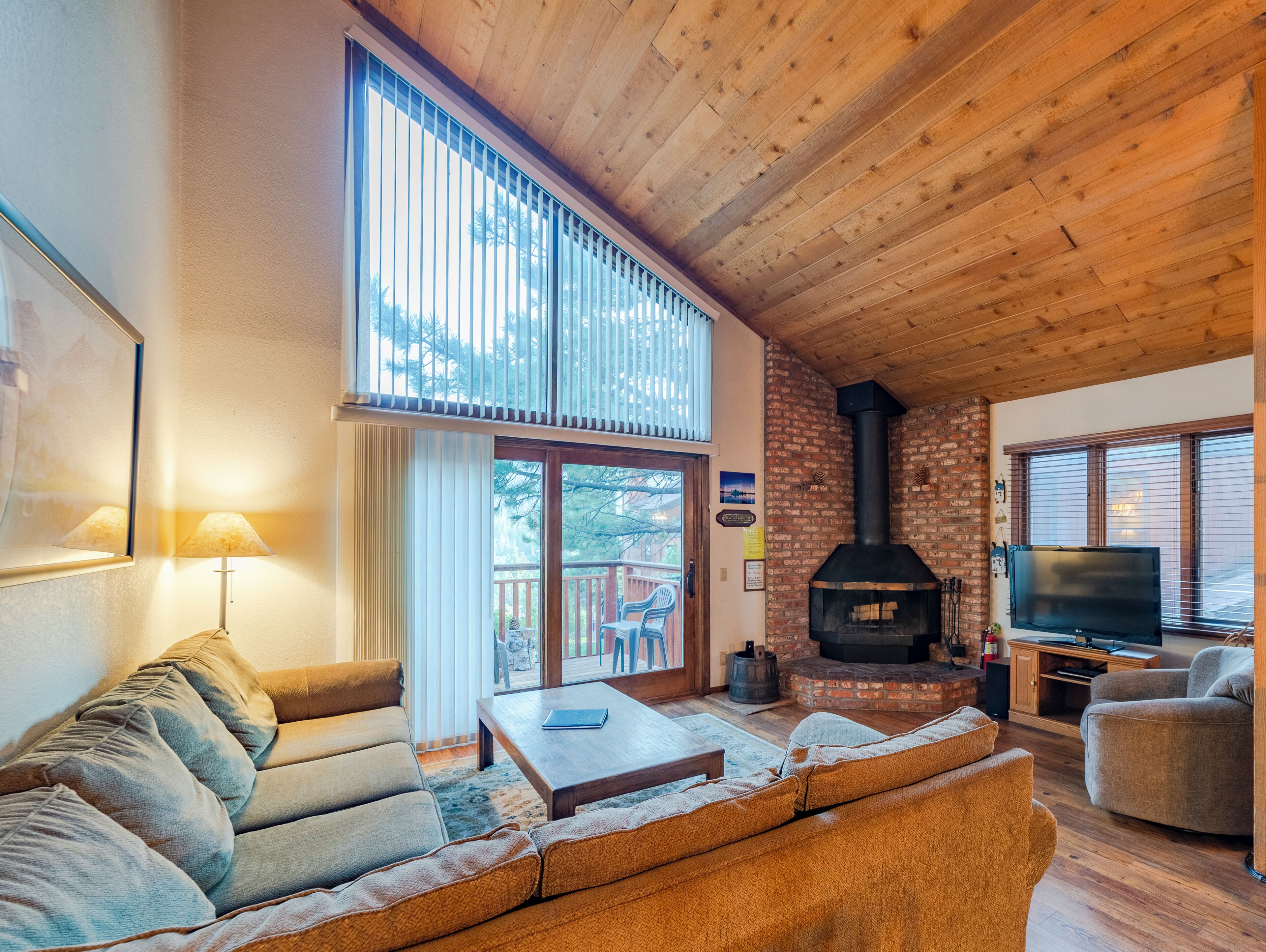 A cozy living room with a fireplace, comfortable seating, and a television.