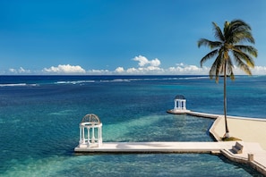On the beach, white sand, beach cabanas, beach umbrellas