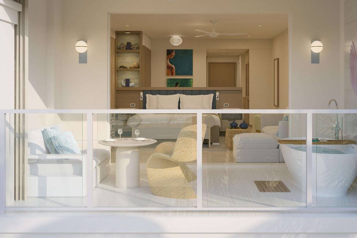Une chambre d’hôtel moderne dotée d’un balcon, d’un coin repas et d’une salle de bain avec baignoire.