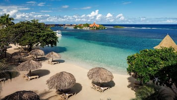 On the beach, white sand, beach cabanas, beach umbrellas