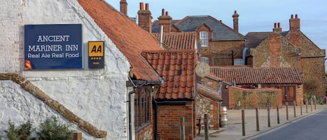 A building with a sign for 'Ancient Mariner Inn' and a 'AA' logo indicating a hotel.