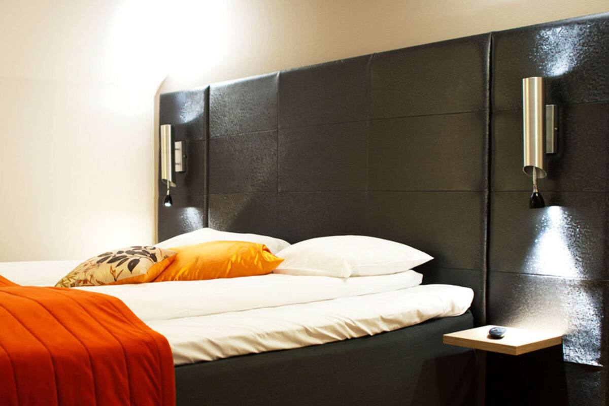 desk, iron/ironing board, bed sheets