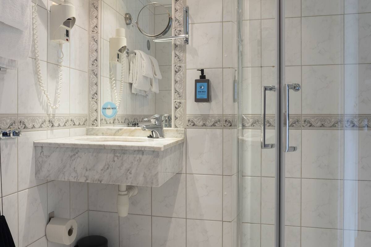 shower, hair dryer, towels, soap