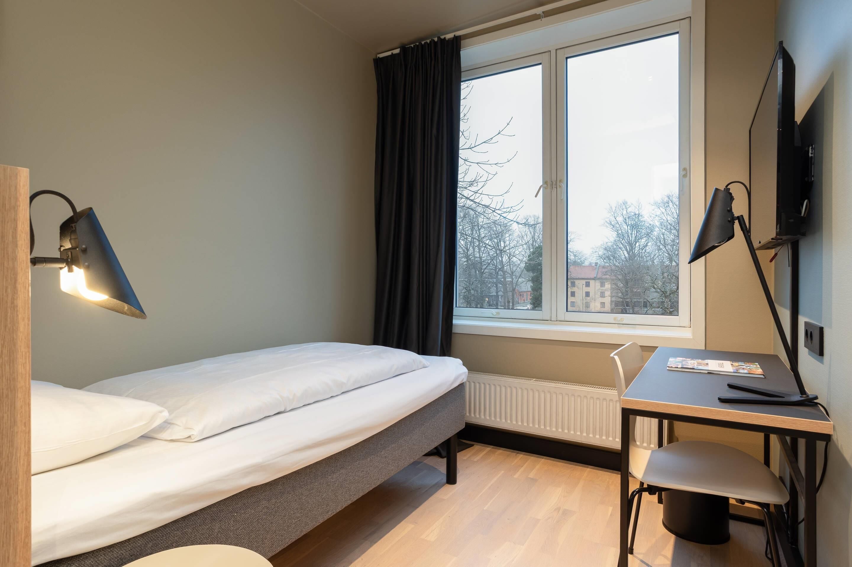 Desk, iron/ironing board, bed sheets