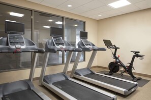 A gym with treadmills, an elliptical, and a stationary bike. - Hilton Garden Inn Cleveland Downtown (Cleveland)