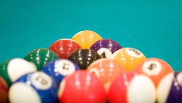 A close-up of a pool table with colorful billiard balls.